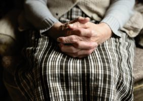 Hands of elderly woman clapsed