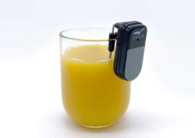 Liquid Level Indicator on the lip of a glass filled with orange juice