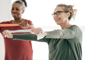 Elderly women working with resistance bands in yoga