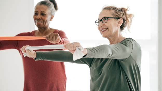 Elderly women working with resistance bands in yoga