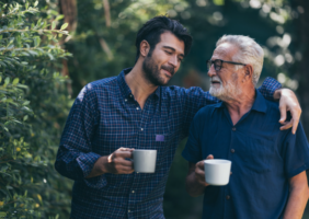 Fther and son in the garden drinking tea together