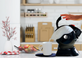 woman pouring the Uccello Kettle in her kitchen