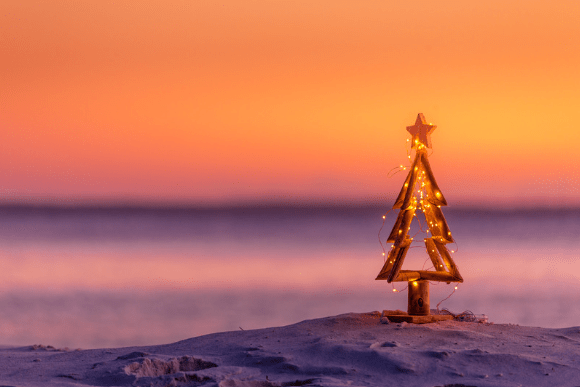 Christmas tree at the beach at sun set