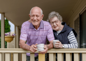 Elderly couple enjoying a cup of tea on their deck
