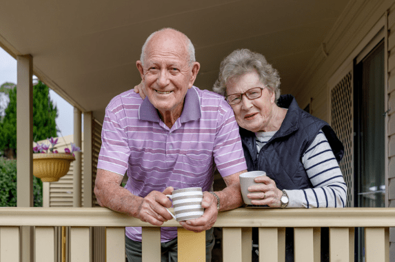 Elderly couple enjoying a cup of tea on their deck