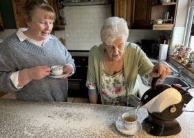 Mother making tea with Uccello Kettle and daughter drinking hers