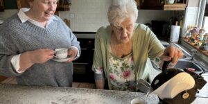 Mother making tea with Uccello Kettle and daughter drinking hers