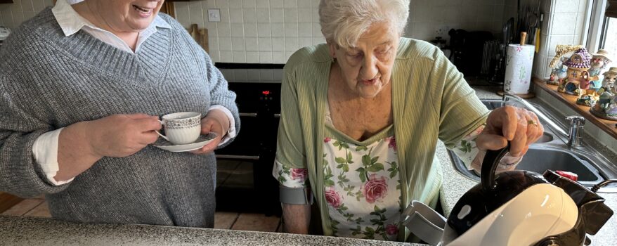Mother making tea with Uccello Kettle and daughter drinking hers