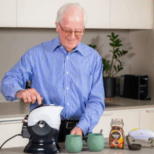 Elderly man making coffee with the Uccello Tipping Kettle