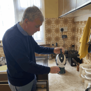 Elderly man making tea using the Uccello Tipping Kettle