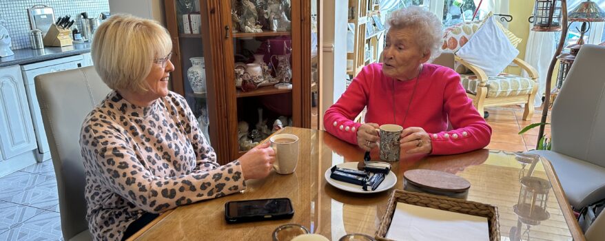 Mother and daughter enjoying a cup of tea and a chat