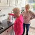 Elderly mother making tea in the kitchen with her daughter