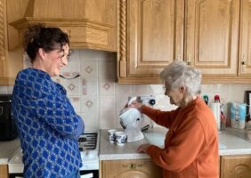 Mother and daughter in the kitchen and making tea