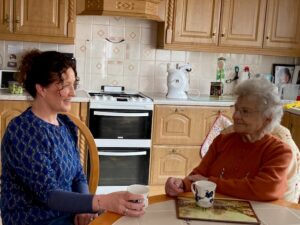 Mother and daughter having tea together in the kitchen