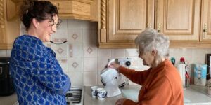 Mother and daughter in the kitchen and making tea