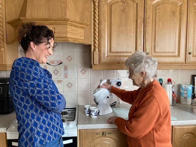 Mother and daughter in the kitchen and making tea