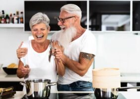 Elderly couple preparing dinner in the kitchen