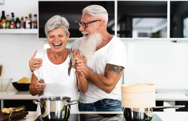 Elderly couple preparing dinner in the kitchen