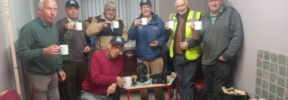 Local Men's Shed Group Photo - 7 Men's Shed Members Circle around the Uccello Kettle and enjoy a cup of tea together