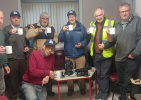 Local Men's Shed Group Photo - 7 Men's Shed Members Circle around the Uccello Kettle and enjoy a cup of tea together
