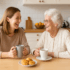Grandmother and granddaughter in the kitchen enjoying a cup of tea together